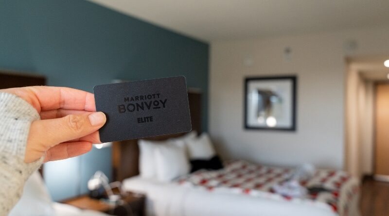Hand holds a Marriott Bonvoy Key Card, black, for elite Ambassador status with the hotel chain