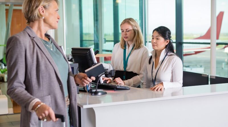 Airport boarding gate agents speak to passenger downgraded