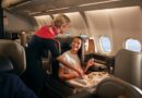 Inflight staff serving food to a female business passenger in the business cabin, Qantas A330