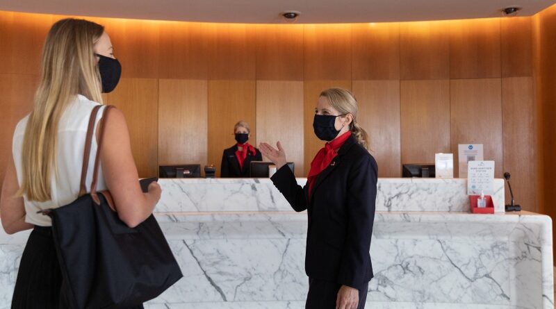 Staff welcome a guest into the Qantas First Lounge in Sydney