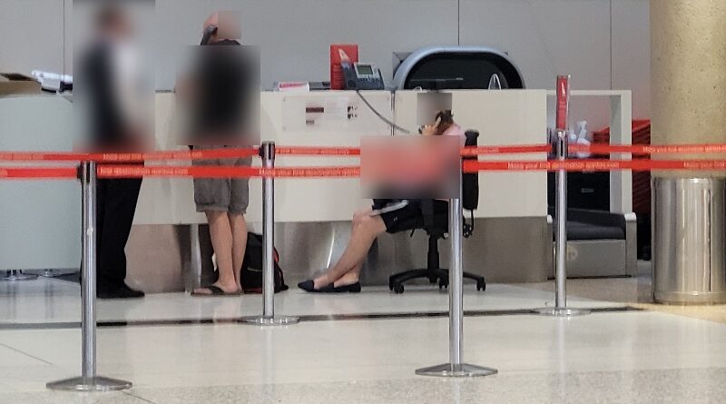 Qantas has "enhanced" the experience for customers at the airport forced to wait hours to speak to the call centre by giving them a chair to sit on while they wait