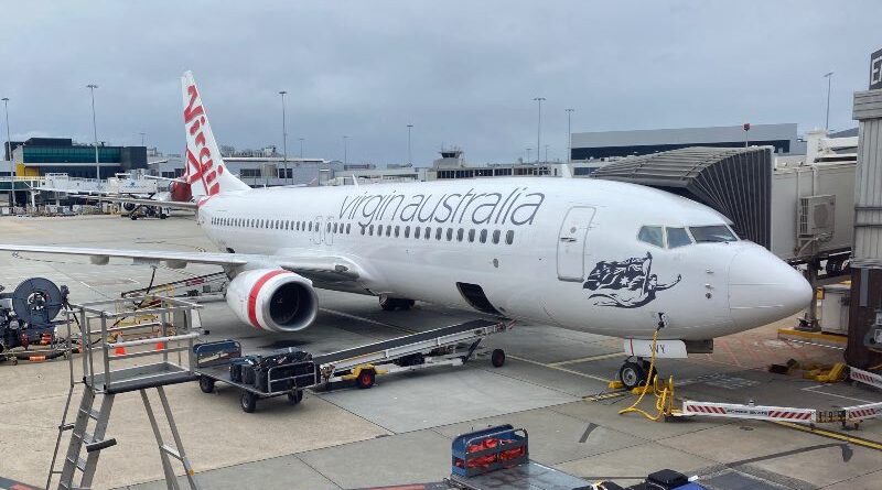 Virgin Australia Boeing 737-800 at Melbourne Airport, Qantas plane behind