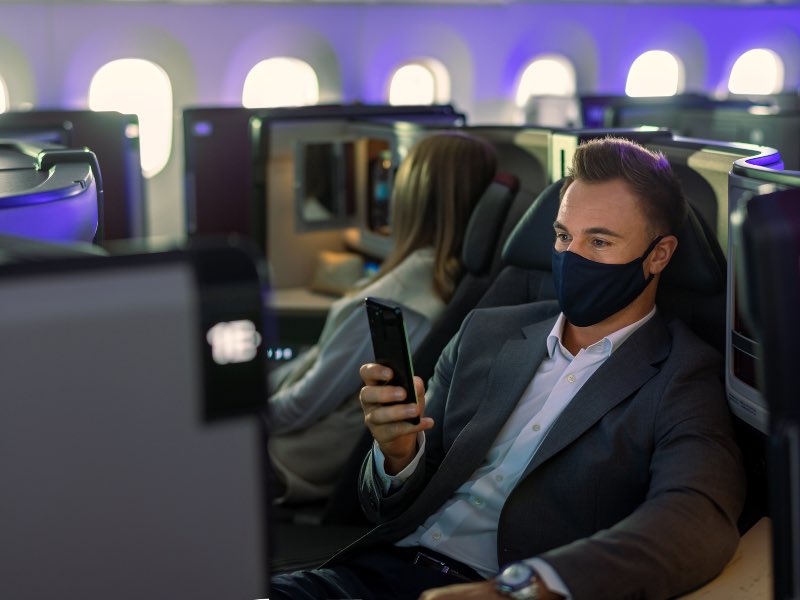 Qatar Airways 787 business passenger using phone