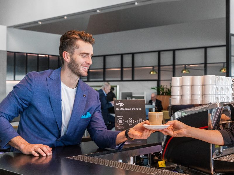 Qantas Club member receiving coffee from barista