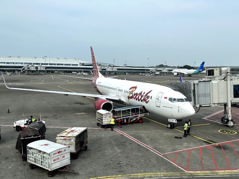 A Batik Air Indonesia Boeing 737-800 with Garuda Indonesia plane in background at CGK