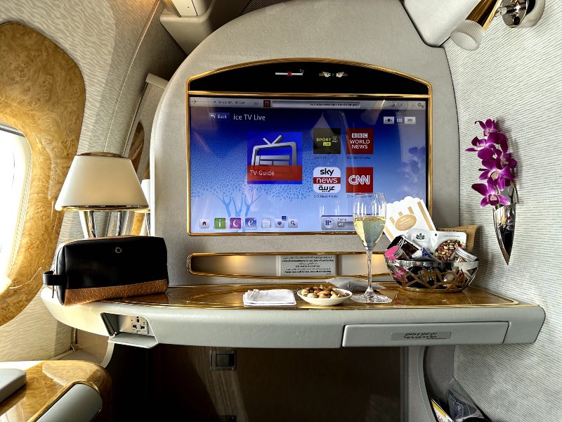 Emirates champagne and nuts with live TV in the background on the IFE screen