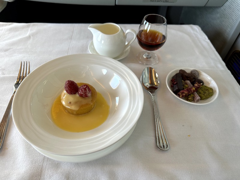 Orange and almond cake, served with lemon curd, crème anglaise, fine luxury chocolates and a Hennessy Paradis cognac in Emirates First Class
