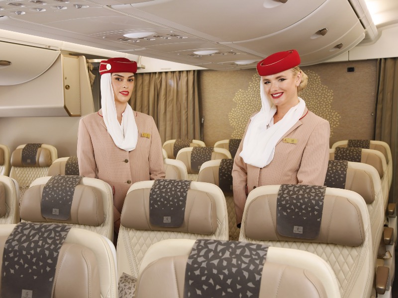 Emirates flight attendants show off the airline's new A380 Premium Economy cabin