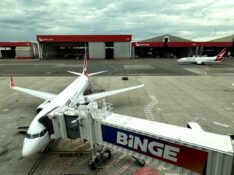 Qantas 737s at Sydney Airport, hangars in background