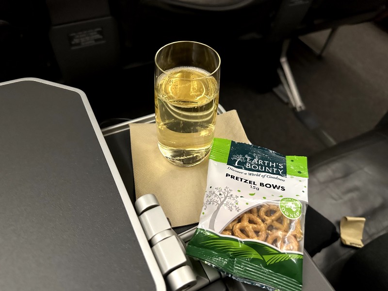 Jetstar's business class meal service begins with a drink and some pretzels
