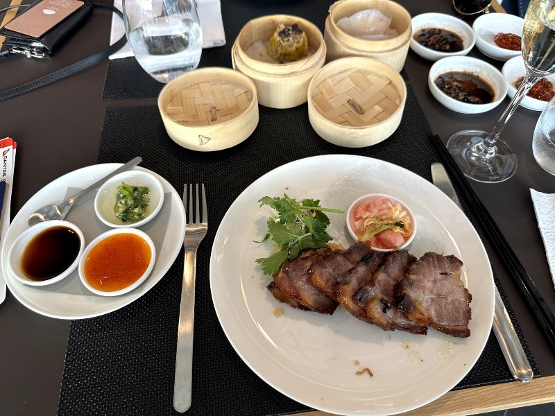 House made BBQ pork with steamed rice, smashed cucumber salad, cabbage and radish pickles at Qantas Hong Kong lounge