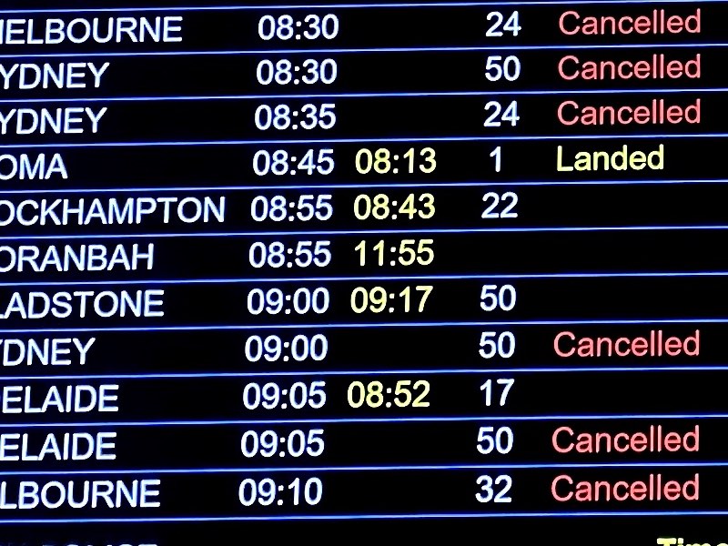 Brisbane airport departures board showing many cancelled flights