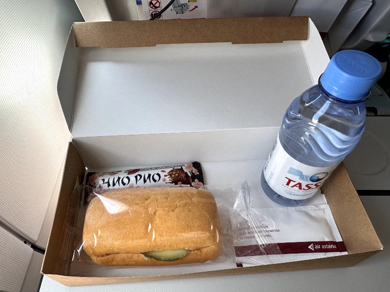 Sandwich, chocolate and water served in a box in Air Astana economy class