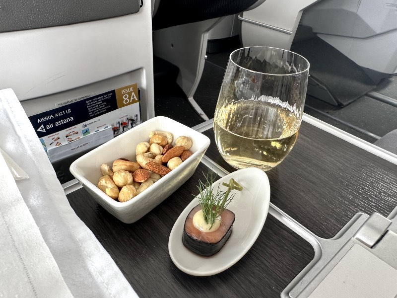 An amuse-bouche and nuts to start the meal in Air Astana Business Class