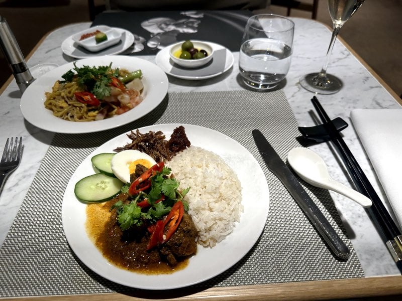 Nasi lemak and Linda's seafood noodles at the Qantas First Lounge in Singapore