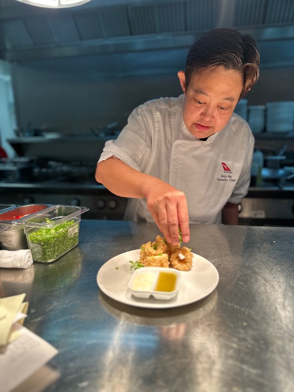 Chef Linda preparing a plate of Qantas' classic salt & pepper squid