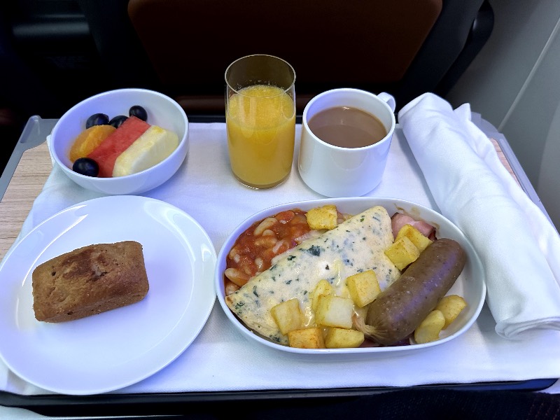 Spinach and feta omelette with bacon, braised beans, potatoes and Hungarian sausage for breakfast in Qantas Premium Economy