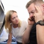 Sick passenger on an airplane with headache