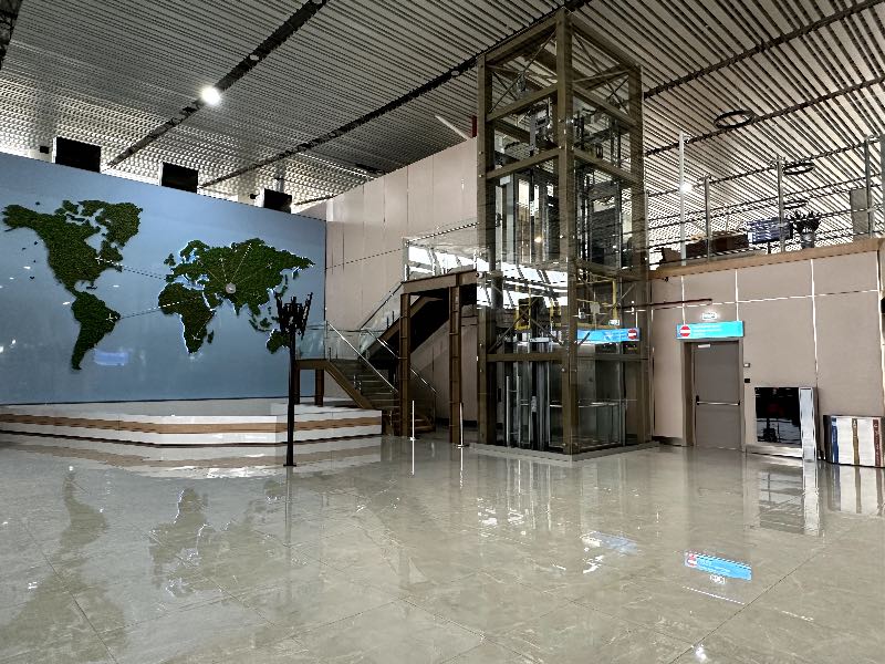 Entrance to the CIP lounge at Samarkand Airport with a world map in the background