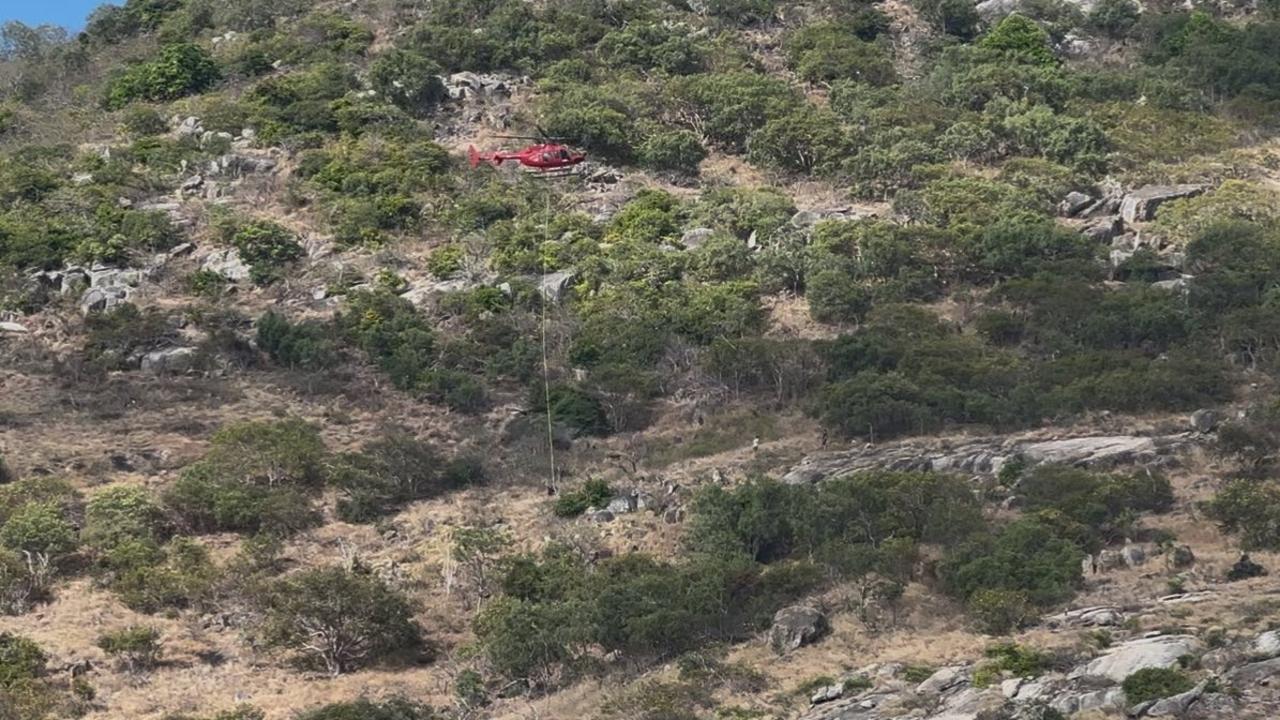 A helicopter searches for the body of the missing Coral Adventurer passenger on Lizard Island, off Cooktown, on Sunday. Picture: Traci Ayris