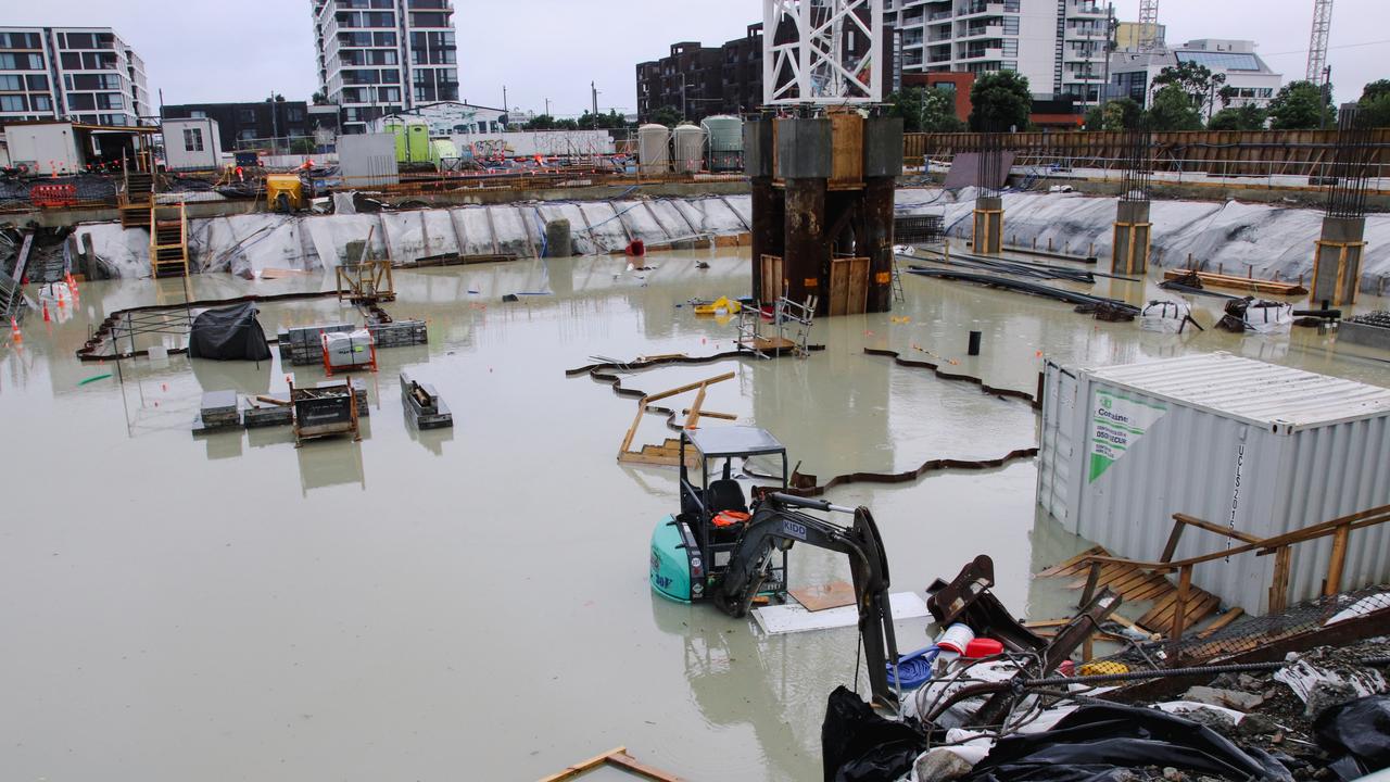 A digger is submerged in a flooded construction site in the Wynyard Quarter in Auckland.
