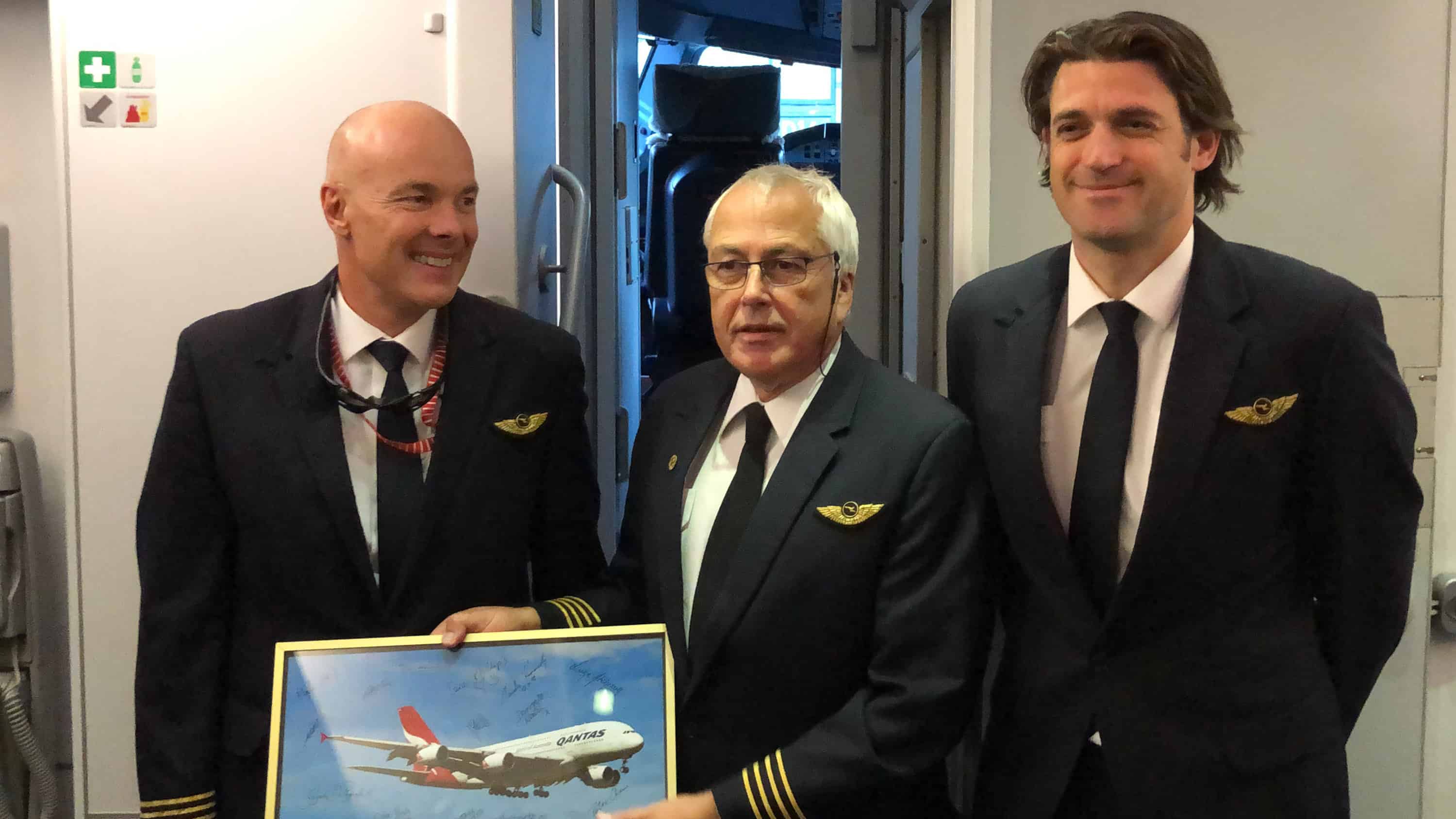 jb747, pictured here with the other pilots from QF36, is presented with a gift after his final flight