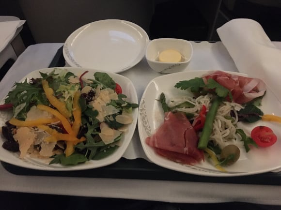Western appetizer of prosciutto slice with salad and a mixed seasonal salad