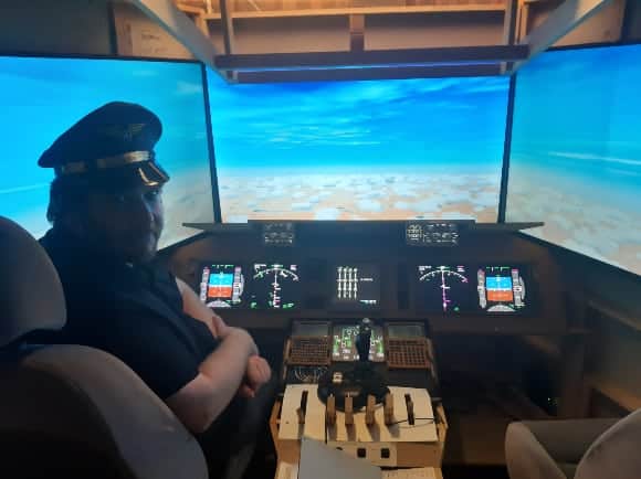Andrew Newnham in the Boeing 747 flight simulator he built in his garage