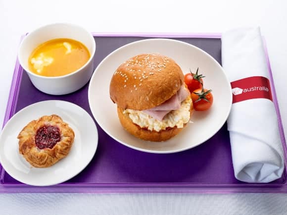 Ham and scrambled egg brioche roll with tomato relish, Greek yoghurt with mango coulis and a Danish pastry