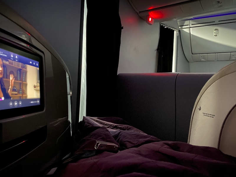 The Air New Zealand 787 Business Class seat converts to a fully-flat bed with bedding provided