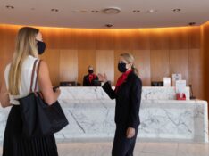 Staff welcome a guest into the Qantas First Lounge in Sydney