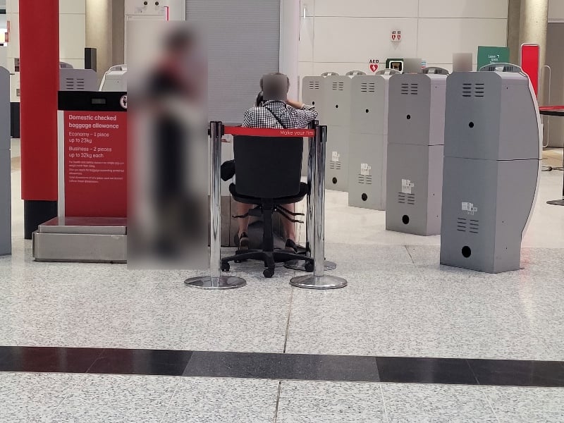 Recognising they'll be in for a ridiculously long wait, Qantas airport staff are now giving customers a seat if they have to phone the call centre