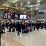 Qantas passengers queue at Melbourne Airport