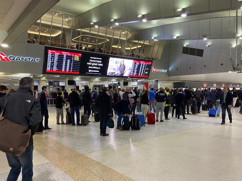 Qantas passengers queue at Melbourne Airport