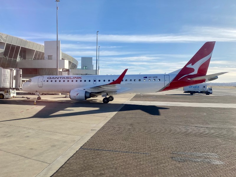 QantasLink Embraer E190 at Canberra Airport with dnata catering truck