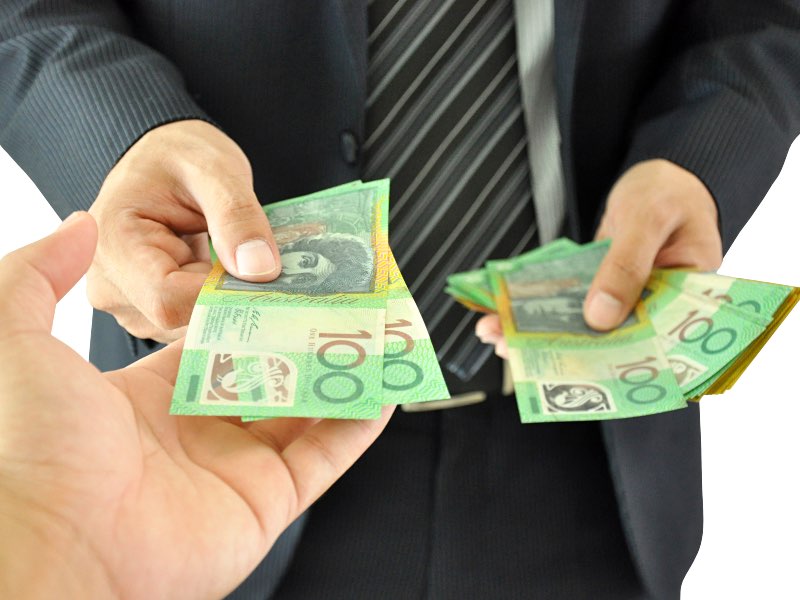 Businessman hand giving money - Australian dollars